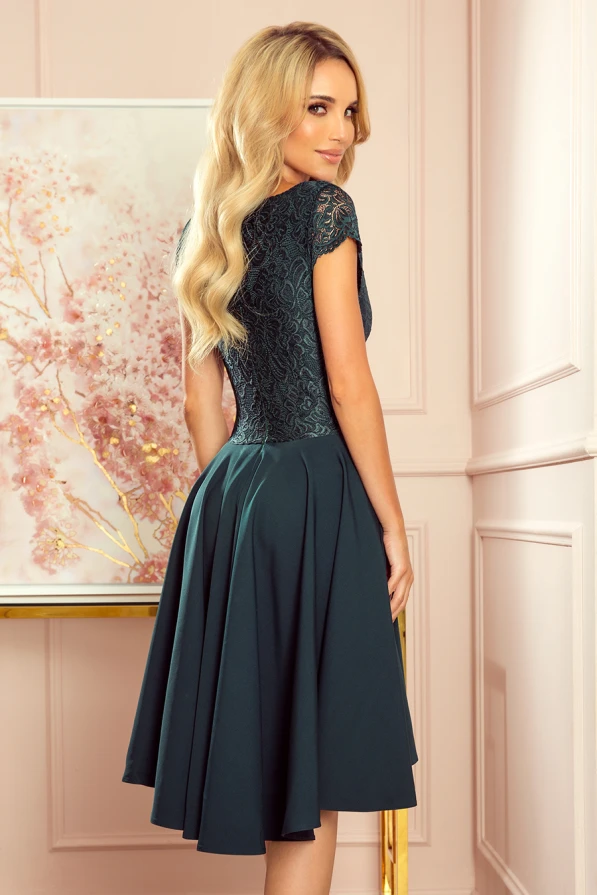 Elegantes, dunkelgrünes Kleid mit Spitzenoberteil und fließendem, ausgestelltem Rock. Perfekt für besondere Anlässe, kombiniert es klassische Eleganz mit modernem Design.